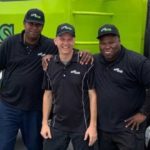 Junk Boss team standing in front of truck ready for Spring Cleaning Services
